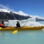 Kayaking among icebergs on Tasman Lake, New Zealand.