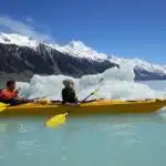 Kayaking among icebergs on Tasman Lake, New Zealand.