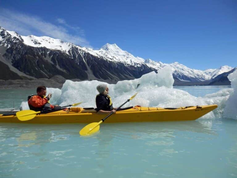 Kayaking among icebergs on Tasman Lake, New Zealand.
