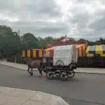 A horse and cart head past the fairground at the Black Country Living Museum in Dudley, West Midlands.