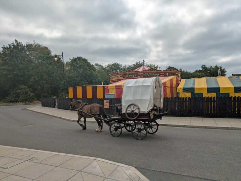 A horse and cart head past the fairground at the Black Country Living Museum in Dudley, West Midlands.