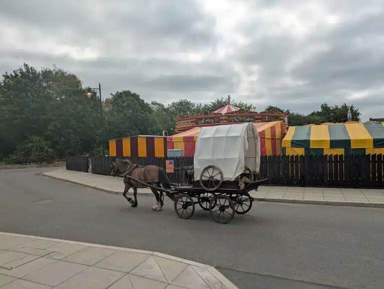 A horse and cart head past the fairground at the Black Country Living Museum in Dudley, West Midlands.