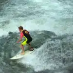 A surfer tackles Munich's Eisbach wave.
