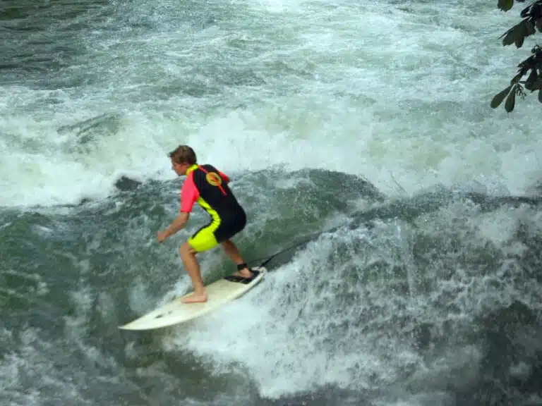 A surfer tackles Munich's Eisbach wave.