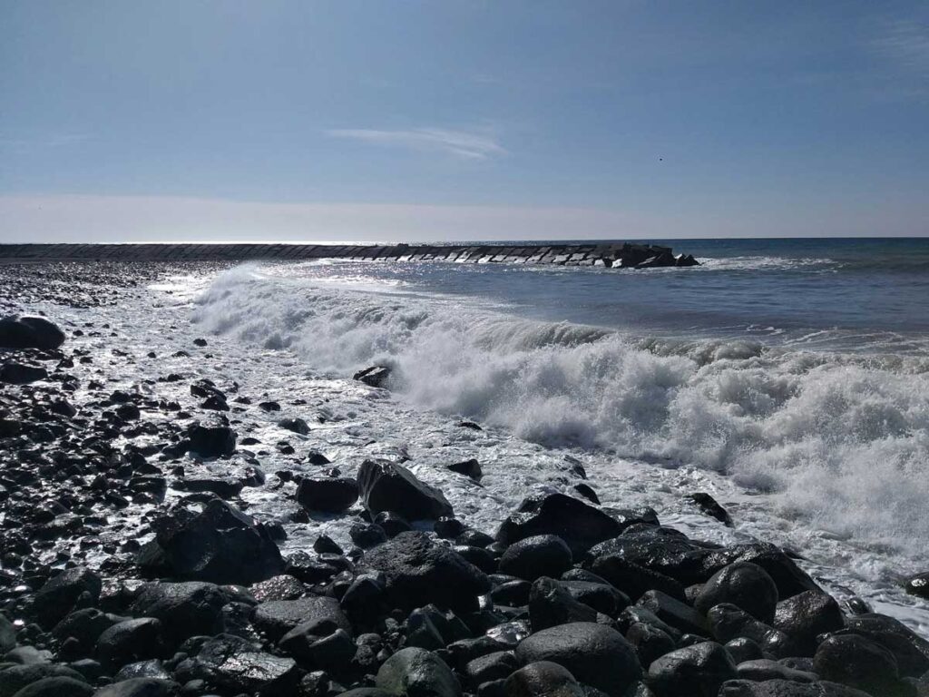 The Atlantic Ocean waves at Ribeira Brava Beach in Madeira, Portugal.