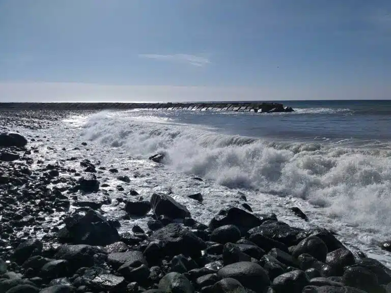 The Atlantic Ocean waves at Ribeira Brava Beach in Madeira, Portugal.