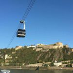 The cable car crosses the Rhine in front of the Ehrenbreitstein Fortress in Koblenz.