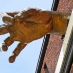 "Pinch" --- The Giant Golden Hand art installation by Adam Kurtzman outside the American Visionary Art Museum in Baltimore, Maryland, USA.